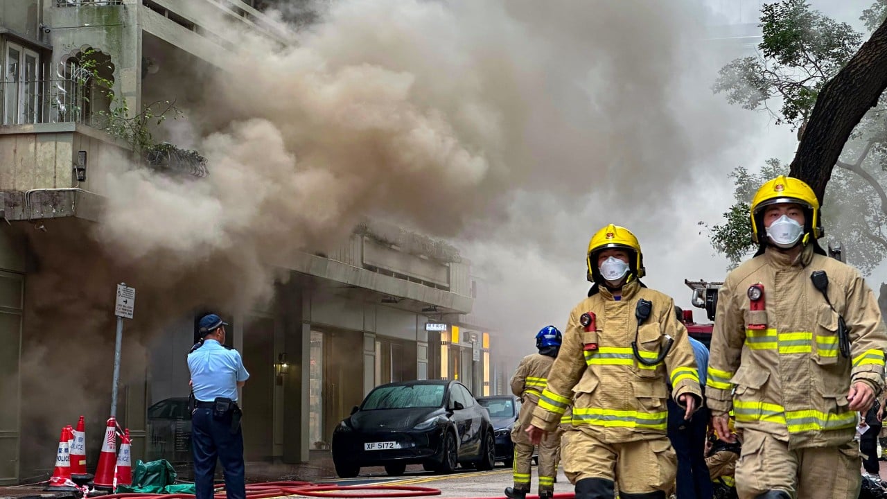 Fire erupts in Hong Kong shopping district, with smoke billowing into streets
