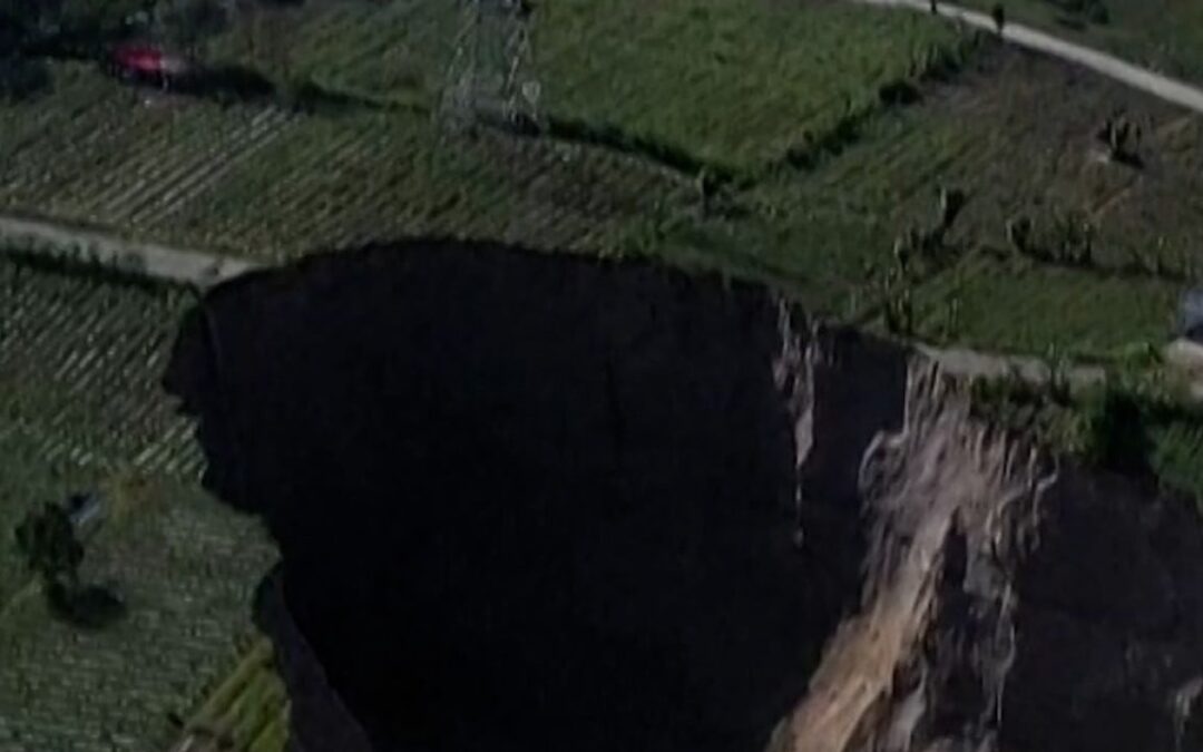 Indonesian village at risk of being swallowed by 100-metre-deep sinkhole