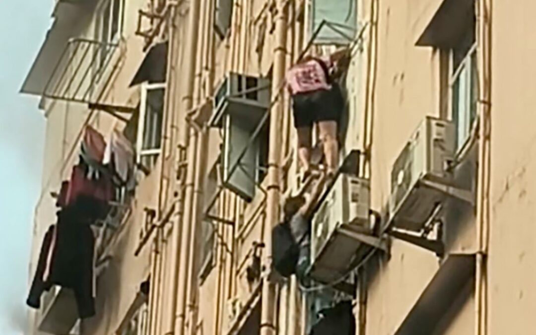 2 women climb out of window to flee Hong Kong building fire that injured 3 others