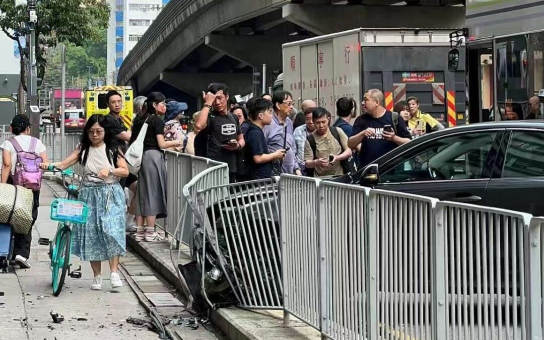 Hong Kong police searching for driver on the run after hitting railing and bus