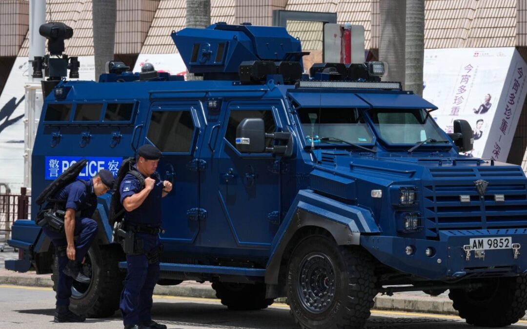 Hong Kong police search 15 in former July 1 protest areas, man taken away
