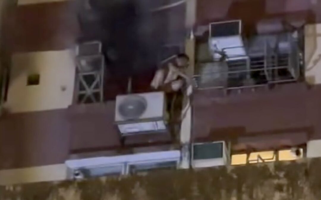 Boy, 13, rescued after climbing onto air-conditioning unit to escape fire in flat