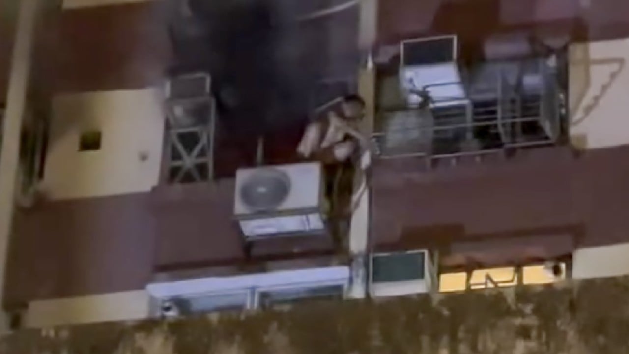 Boy, 13, rescued after climbing onto air-conditioning unit to escape fire in flat